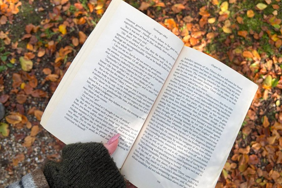 Northanger Abbey held open over a ground of fallen autumn leaves